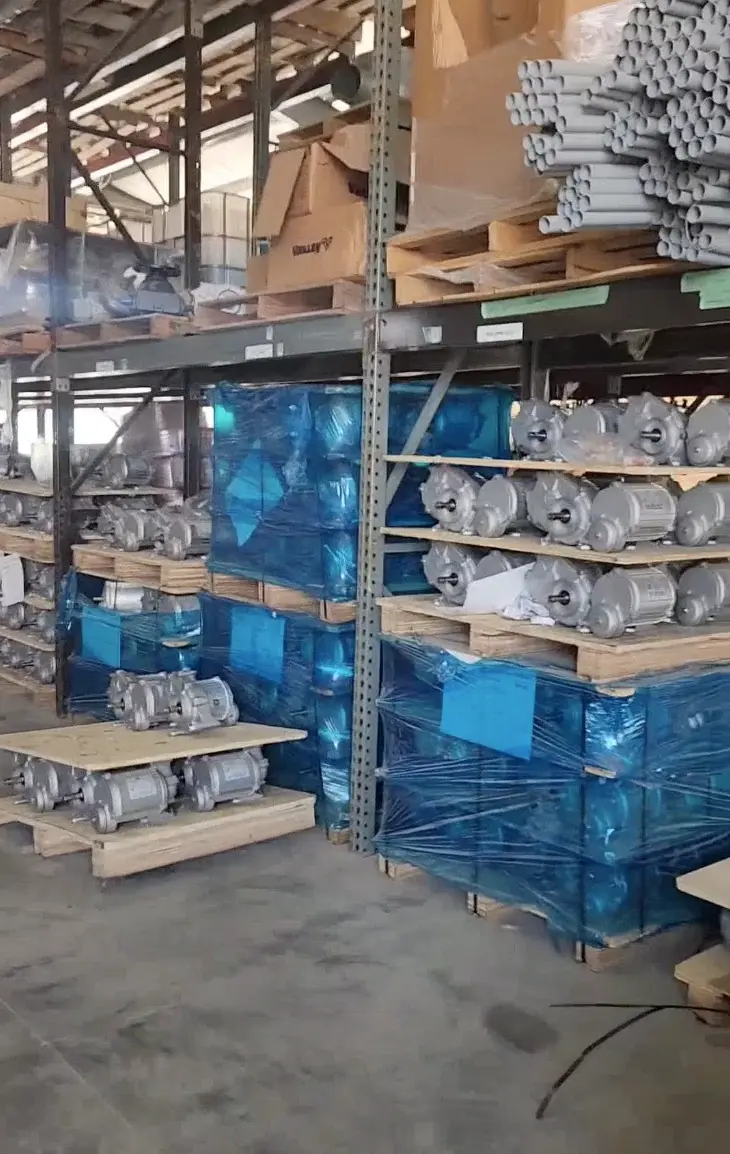 Warehouse shelves stocked with center pivot gearboxes and parts